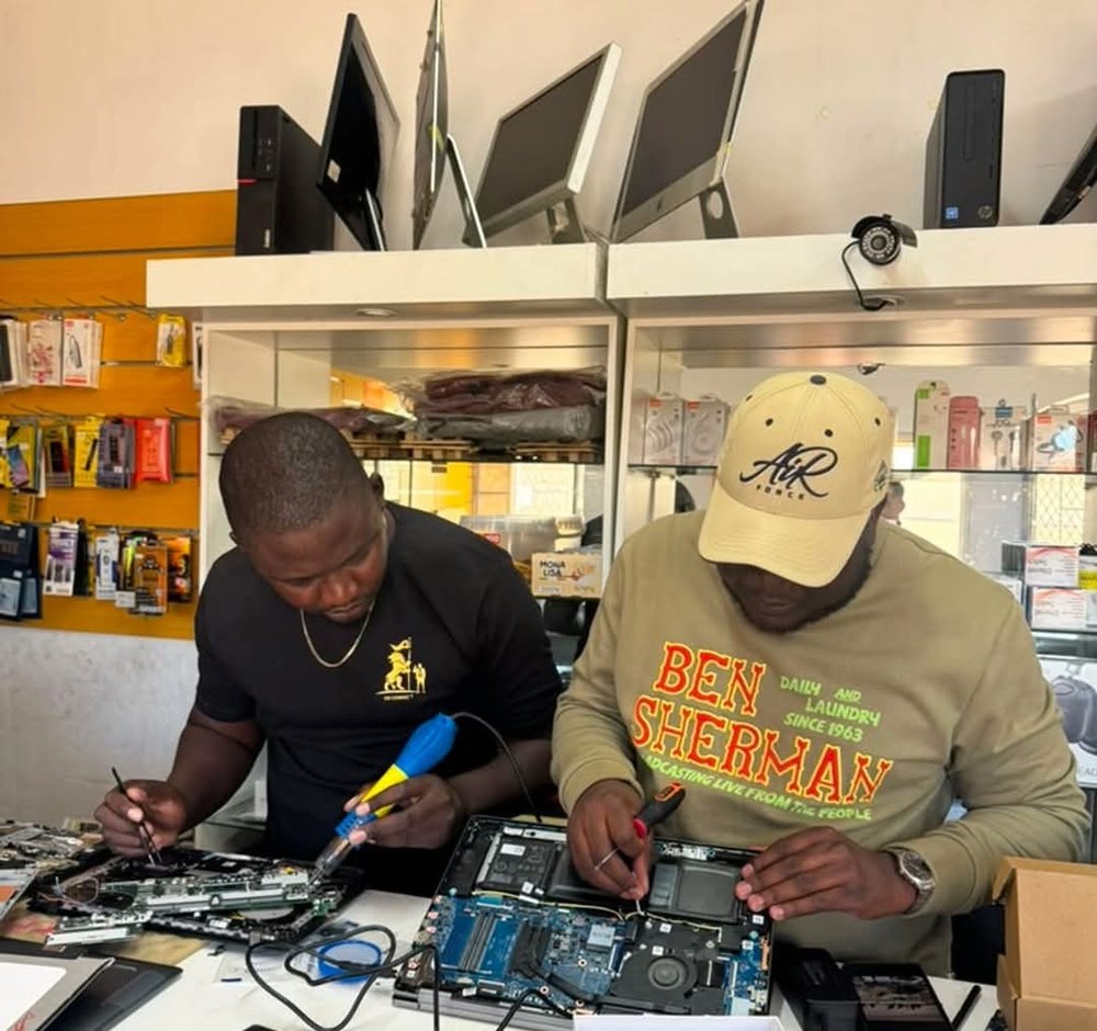 DX Connect technicians repairing a laptop